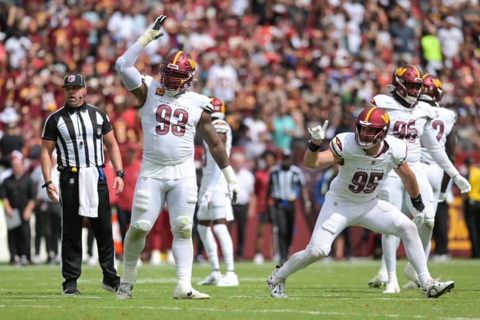 Sep 10, 2023; Landover, Maryland, USA; Washington Commanders defensive tackle Jonathan Allen (93) and defensive end Casey Toohill (95) celebrate after tackling Arizona Cardinals running back Keaontay Ingram (not pictured) behind the line of scrimmage during the first half at FedExField. Mandatory Credit: Tommy Gilligan-USA TODAY Sports